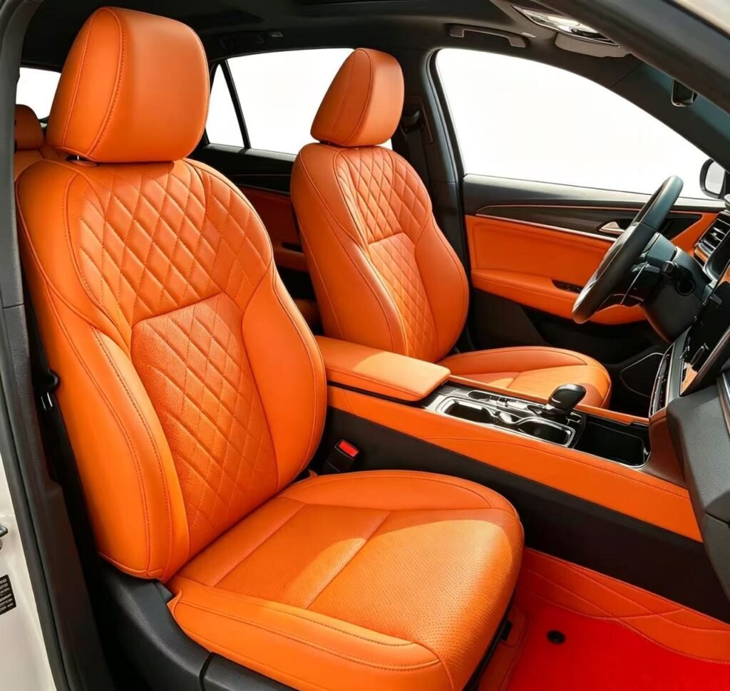 Premium orange custom-fit leather car seat covers installed in a vehicle interior